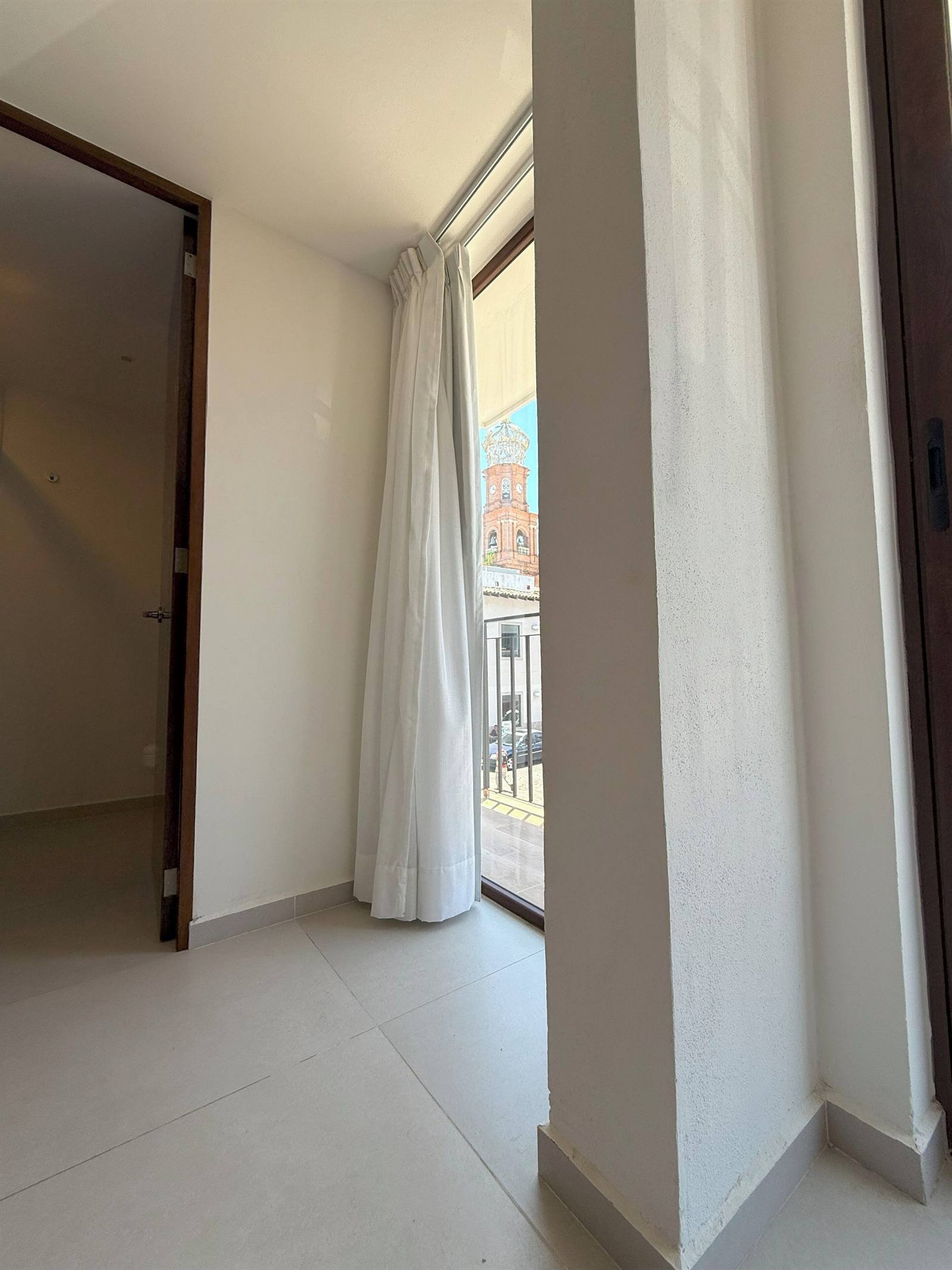 Hotel Casa Kavia: large window looking out at the church's clock tower